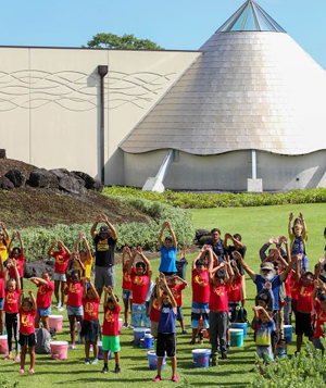 lots of children in red shirts at Imiloa Astronomy Center