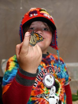 student holding butterfly 