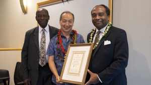 Three men with certificate