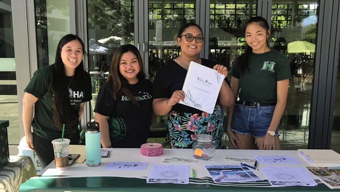 4 people at information table