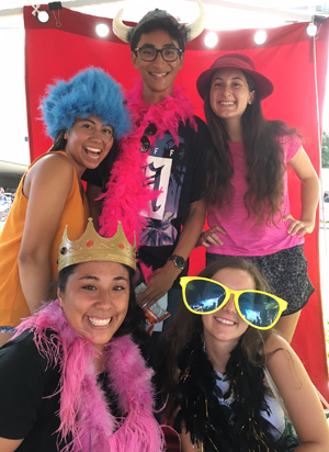 five people posing in photo booth