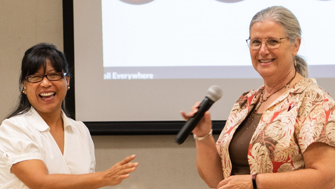 Chancellor Rachel Solemsaas and Chancellor Bonnie Irwin sharing microphone