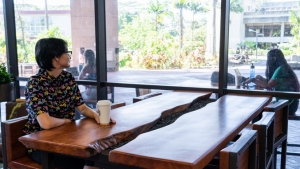 two U H Hilo student sitting in library lounge