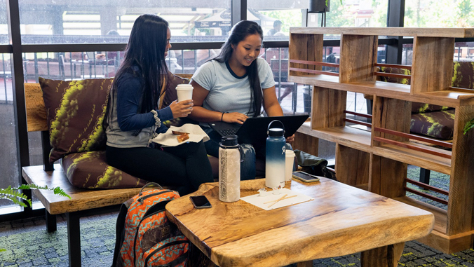 two U H Hilo students sitting in library lounge