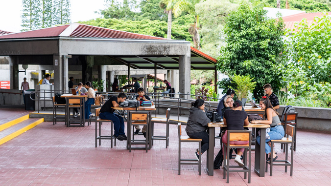 two U H Hilo students sitting in outside lounge