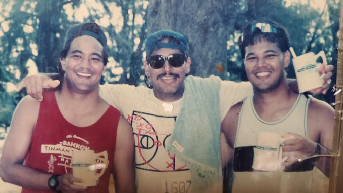 3 men after waving shaka