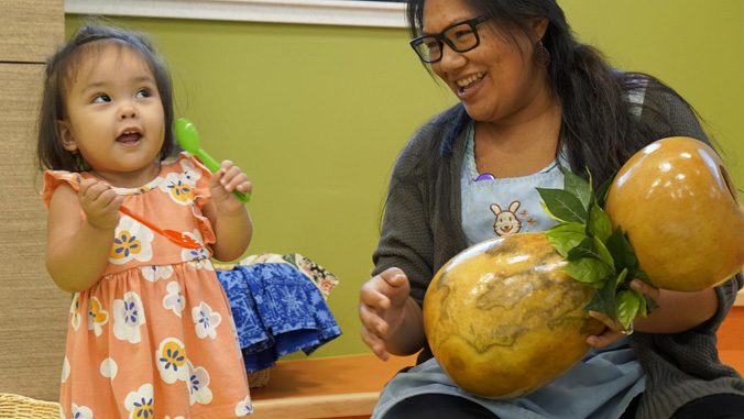 teacher teaching a toddler music