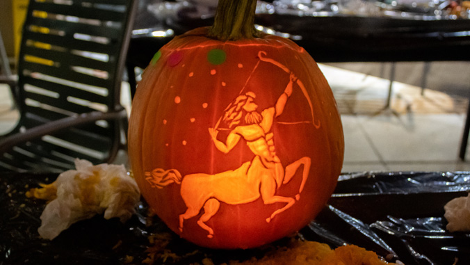 pumpkin with carving of a centaur with a bow and arrow