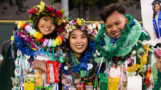 3 U H Manoa graduates wearing lei