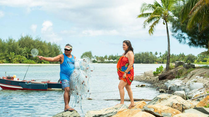 fisherman and woman observing the ocean
