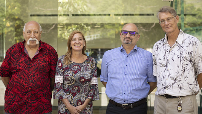 4 people standing in front of I B R lab