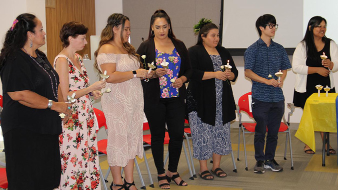 students lighting candles