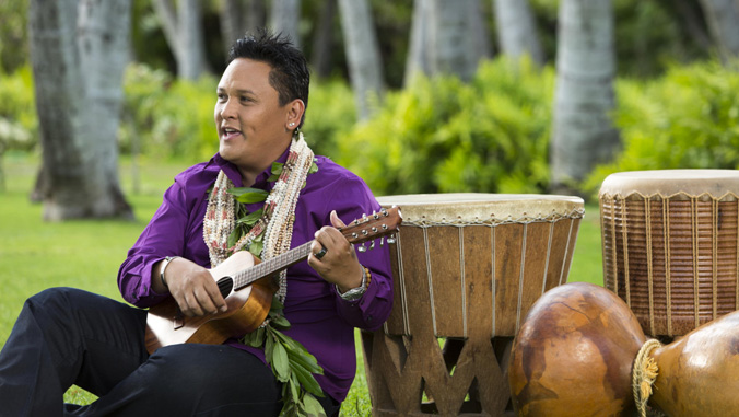 man playing the ukulele