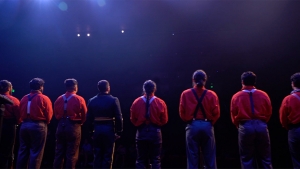 Backs of performers on stage