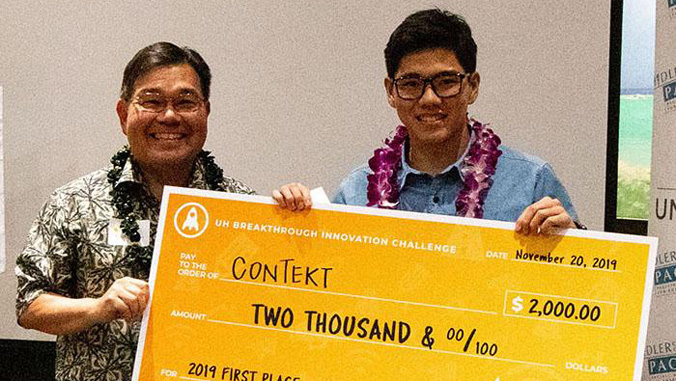 men holding giant check