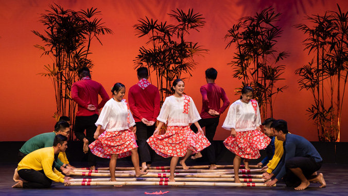 students dancings through bamboo