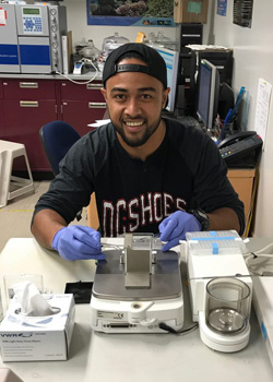 Tonga working on lab equipment