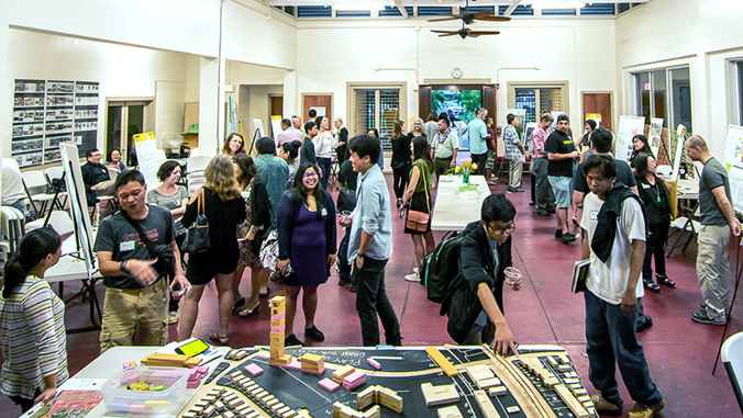 people looking at exhibit and posters