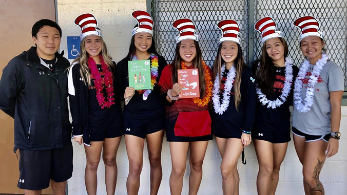 student-athletes with doctor seuss books and hats