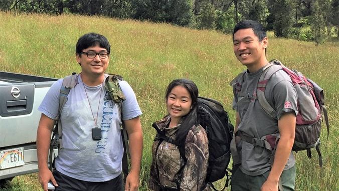 three people in Hawaii Island forest