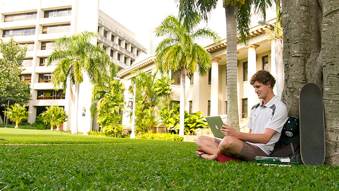 student sitting on the lawn