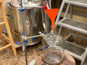 distilling mixture into glass jugs