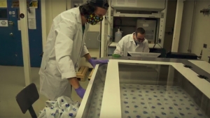 two students use laser cutter