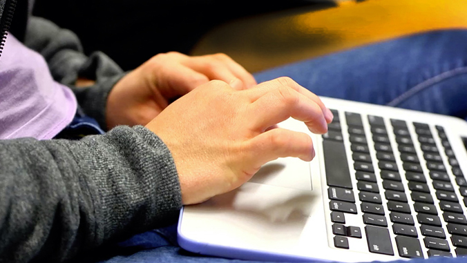 person typing on laptop