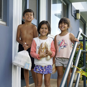 three children holding food containers