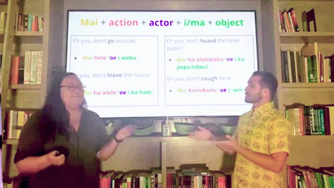 two presenters in front of screen