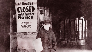 man next to closed theatre sign during 1918 flu