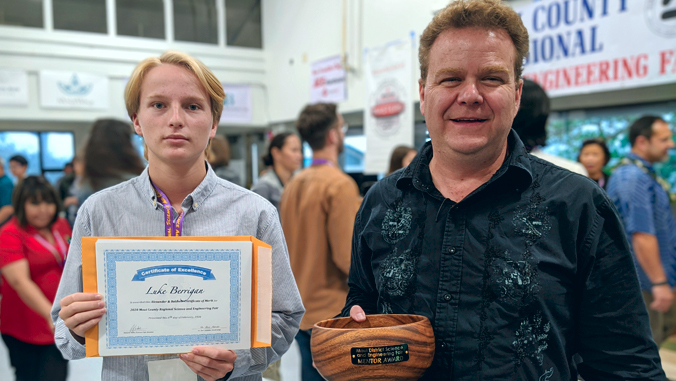 two people holding award