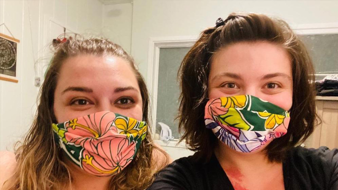 two girls wearing face masks