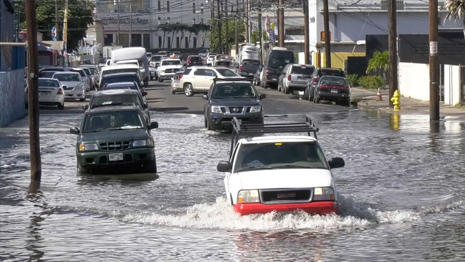 cars driving through flooded area