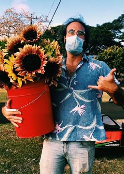 Russell Galanti holding bucket of sunflowers