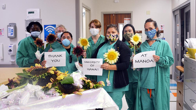 nurses holding papers saying thank you
