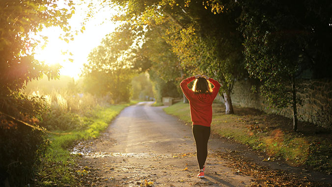 woman going on a walk with hands up