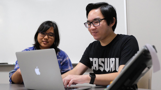 students looking at laptop