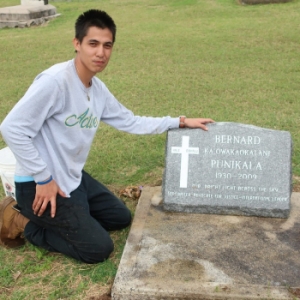 student beside grave marker