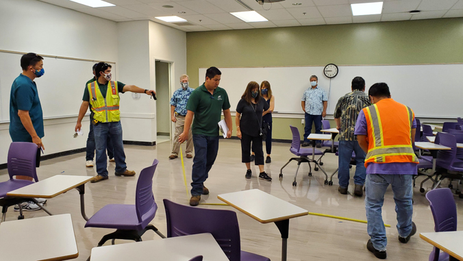 people moving desks in classroom