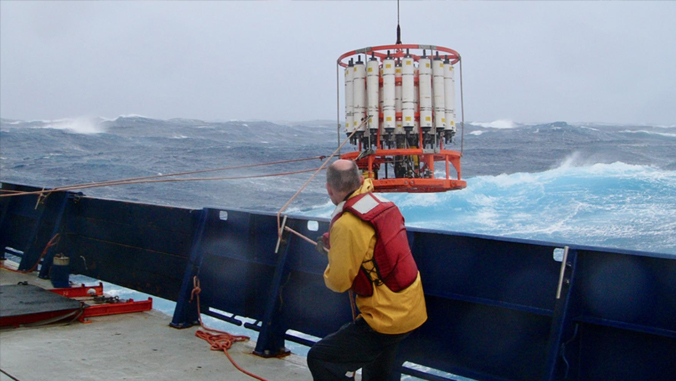 man looking at a wave buoy