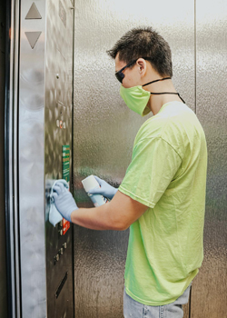 Man spraying an elevator