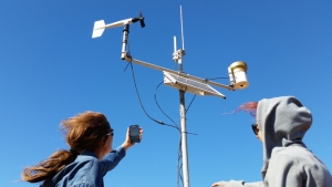 two people working on an outdoor signal system