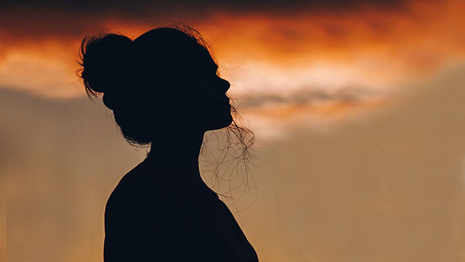 woman with sunset in background