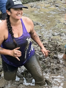 women standing in mud 