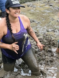 women standing in mud