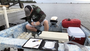 graduate student with water sample bottles