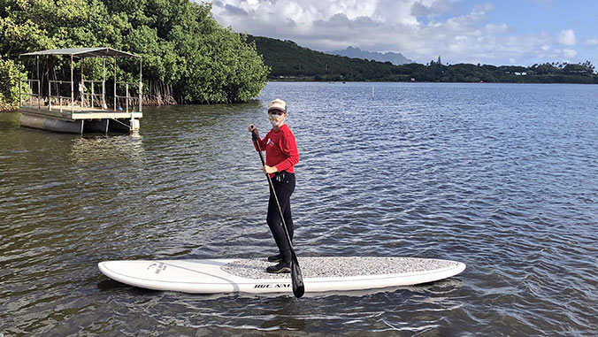 graduate student on paddle board