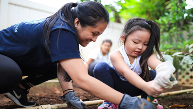 child and parent gardening