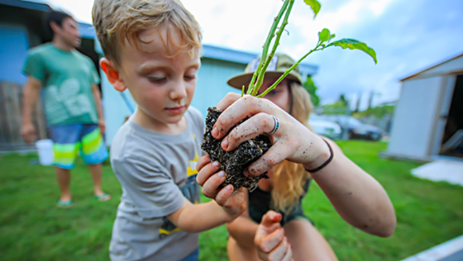 child and parent gardening